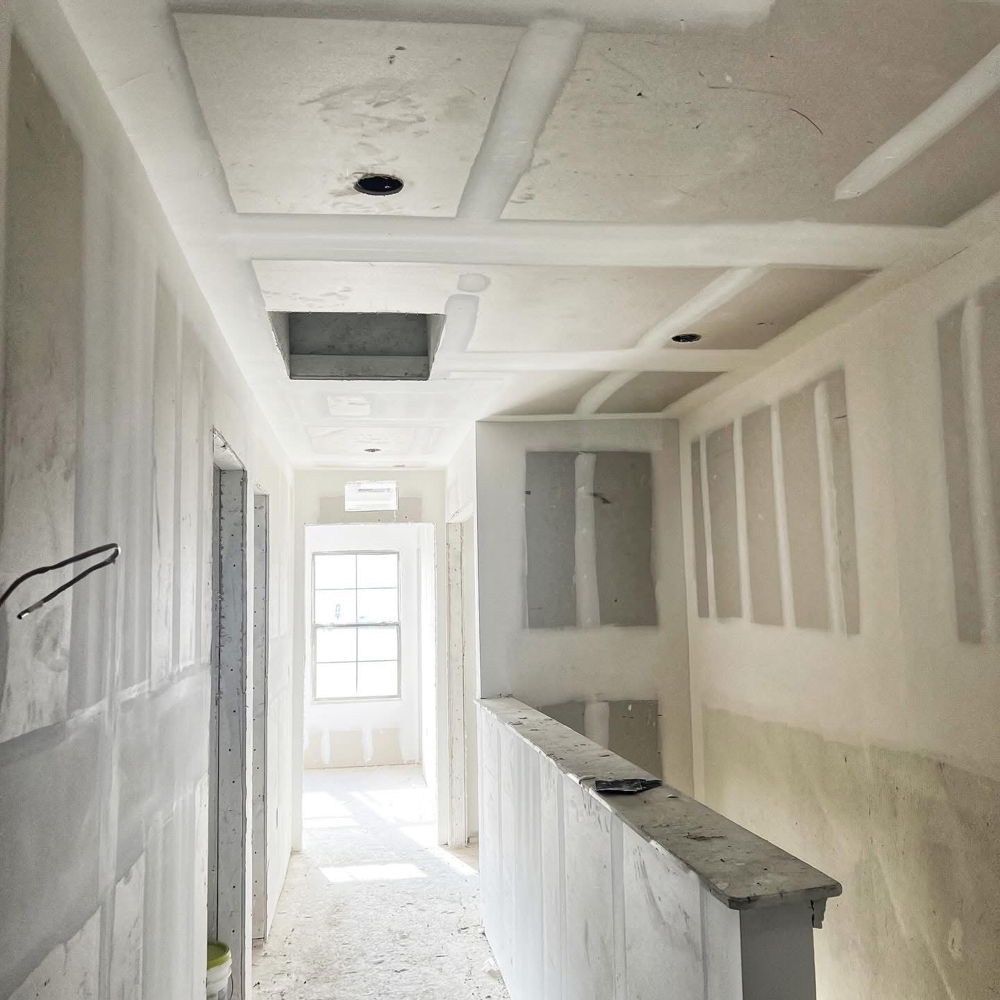 Freshly painted white hallway with smooth ceiling finish