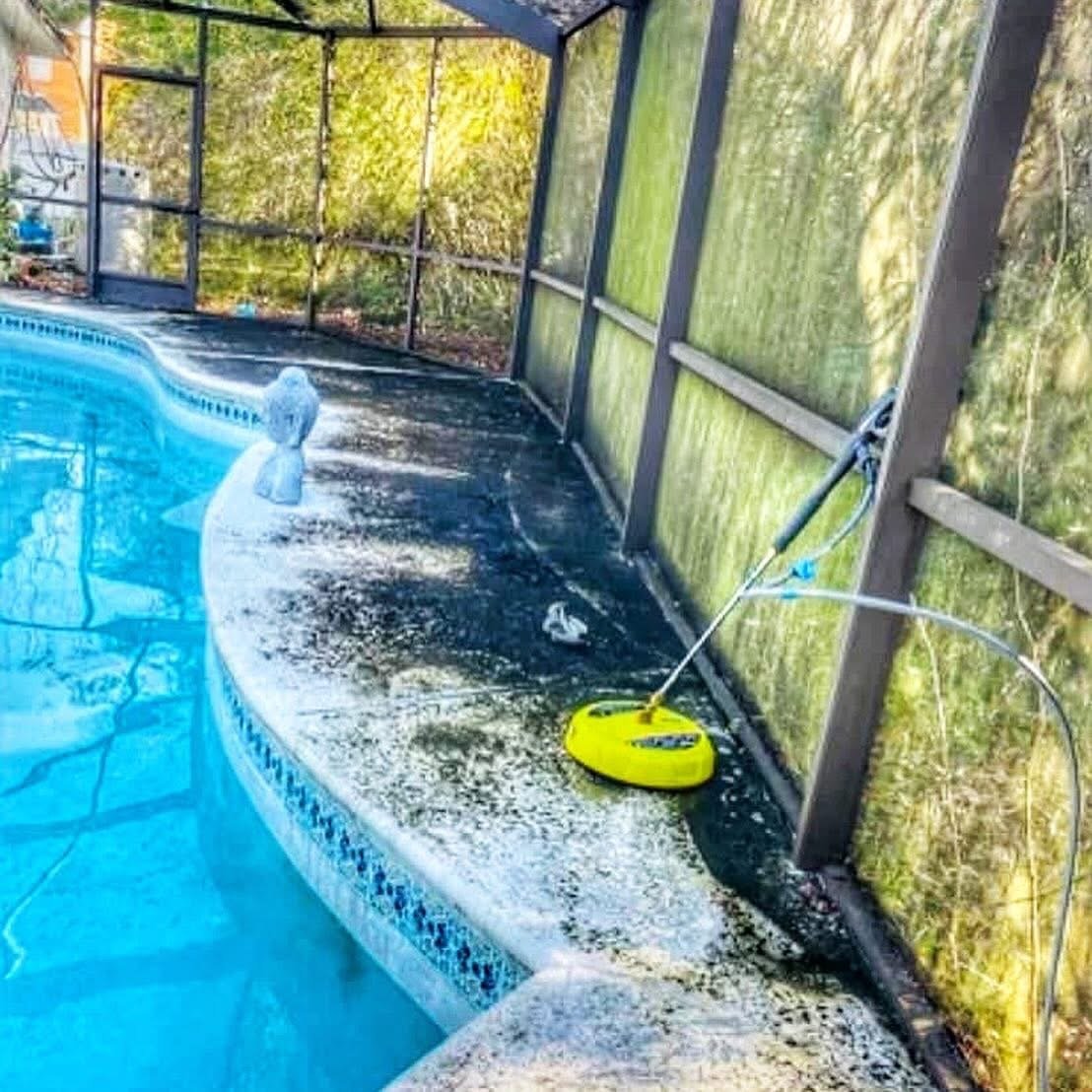 Screened-in pool area surrounded by mature trees in Fruit Cove, FL