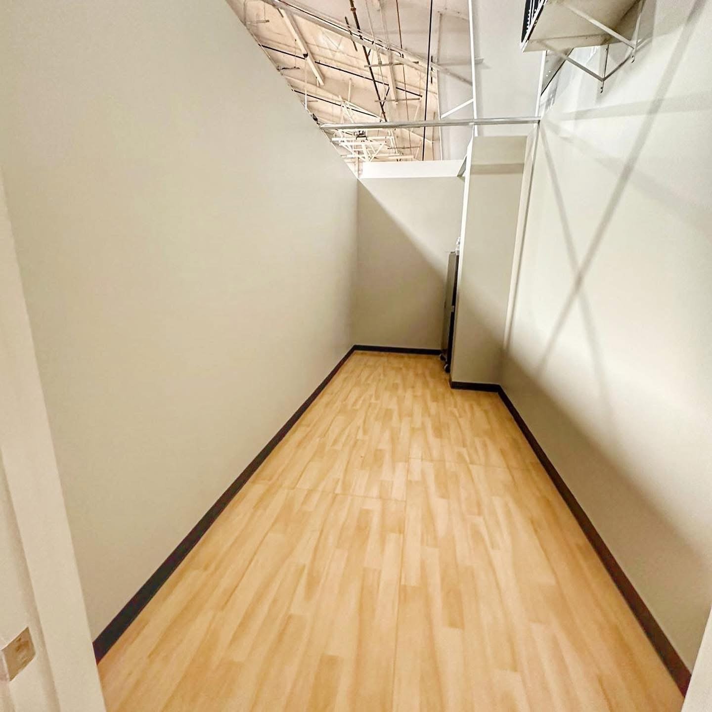 Hallway with light wood-look flooring and freshly finished drywall, drywall by JDF Services Inc in Jacksonville, FL