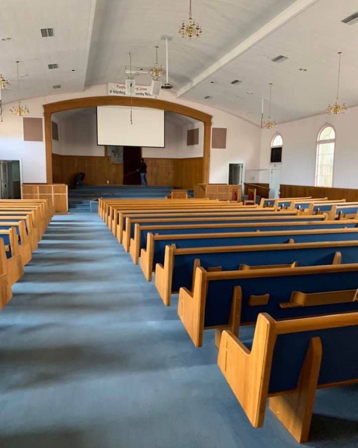 Church interior with wood pews after flooring and painting project
