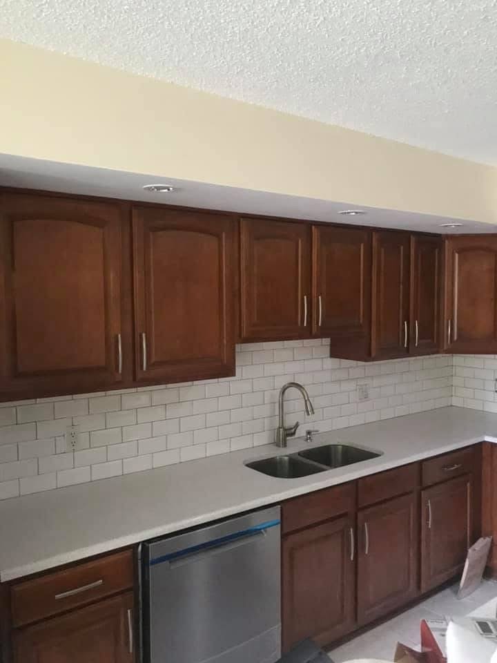 Kitchen with dark wood cabinets and white subway tile backsplash