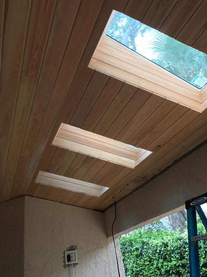 Vaulted wood ceiling with skylight installed by JDF Services Inc